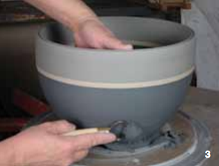 3 After all the sections are added, final throwing and refining of the form is completed. The base of the work is trimmed in the upright position. Later it will be inverted to trim the foot.