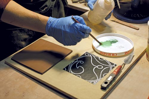 1 Add water to the frit and Mason stain mixture until it’s a consistency that’s repelled well by the toner spaces on the image.