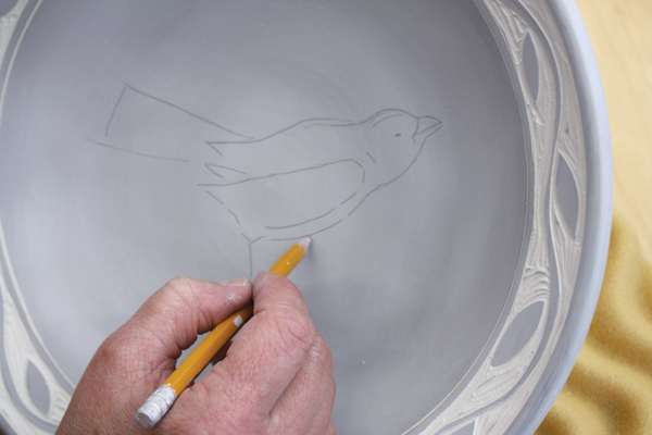 3 After applying terra sigillata to the surface, lightly draw your design on top of the sigillata using a pencil.