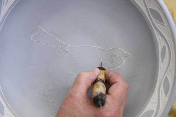4 Use a worn needle tool to outline the images. Don’t use a sharp tool, it will create a jagged line.
