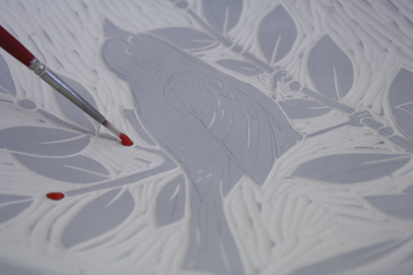 10 Add colored accents to the finished, carved main design or image using commercial underglazes.