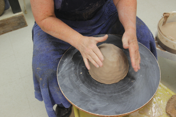 8 Slap centering with dry hands to remove any high points and create straight sides.