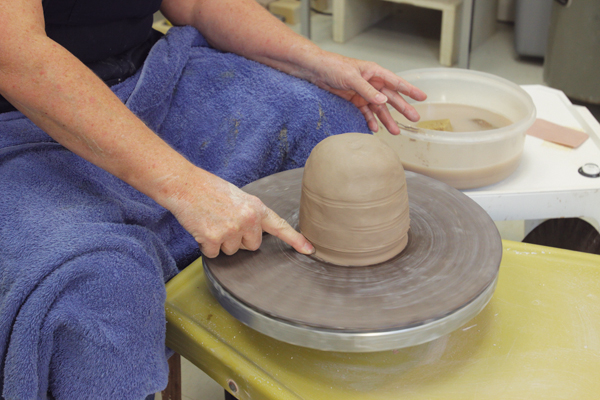 10 Seal the mound to the wheel head by creating a small buttress of clay.