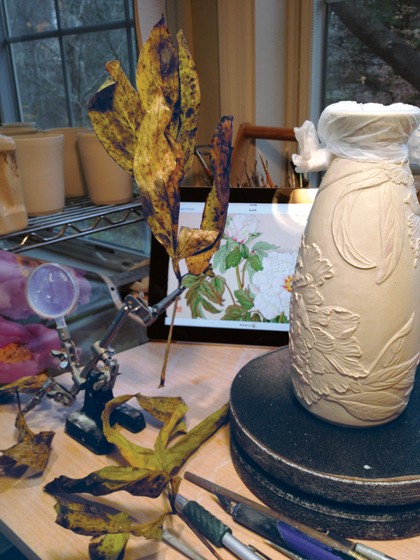 Peony sake set process: This piece was inspired by the Peony woodcuts of Japanese printmaker, Tanigami Konan, as seen on the iPad in the photo. I also use resource photos and live and dried plant specimens.