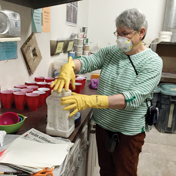 3 MN NICE student mixing glazes for material science project.