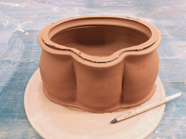 6 Use a rubber-tipped tool to indent the walls of the pot.