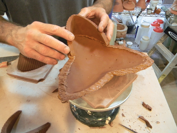 16. Once the base and the curved walls are equally firm, score each attachment area, add slip, and join them together.