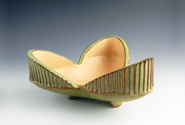 18. Michael Hamlin’s three-lobed Clover dish is decorated with green and cantaloupe matte glazes that he developed as an undergraduate. He typically brushes the glazes on rather than dipping or pouring them. He’s intrigued by the way the matte surfaces offer an overall visual texture.