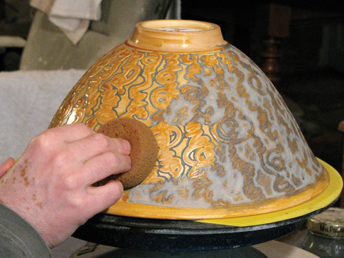 Fig.8 Use a sponge to wipe off any black slip that is not in the etched lines.