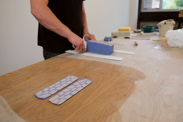 2 Slicing thin slabs from the cane using thickness guides for even consistency.