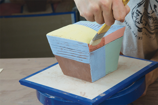 20 Once the box is bone dry, paint underglazes onto the surface.