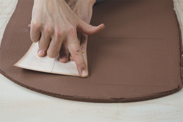 3 Lightly press the template’s edges into the slab.
