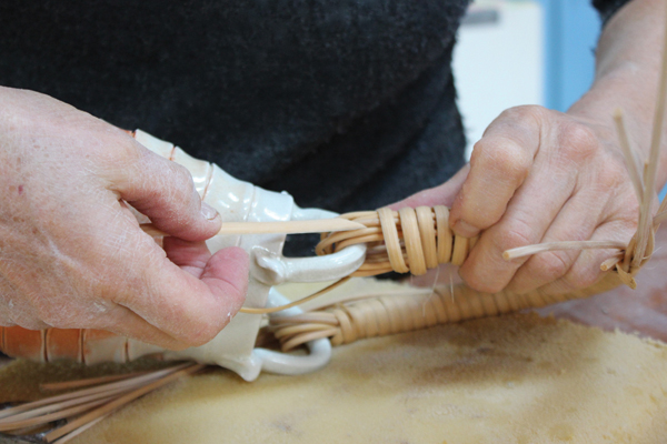 7 After wrapping, cut the flat reed sharply on an angle and feed it back under the wraps as far as possible to secure the end.