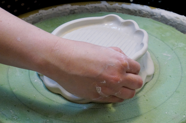 12 Gently pinch and pull the coil about every inch to create a ruffled edge.