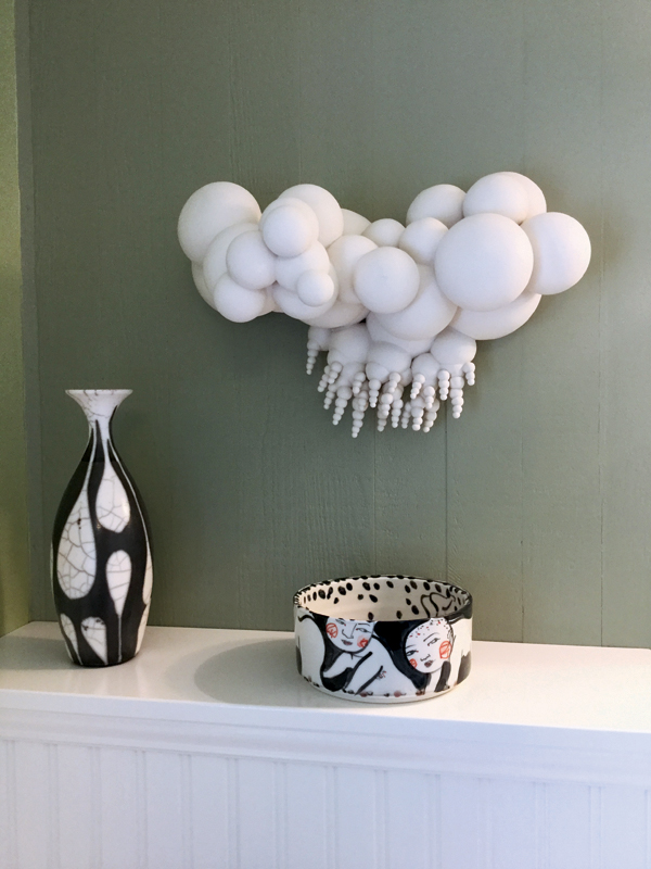 7 Sam Scott’s vase and Akio Takamori’s bowl on a table and Jamie Walker’s sculpture on the wall.