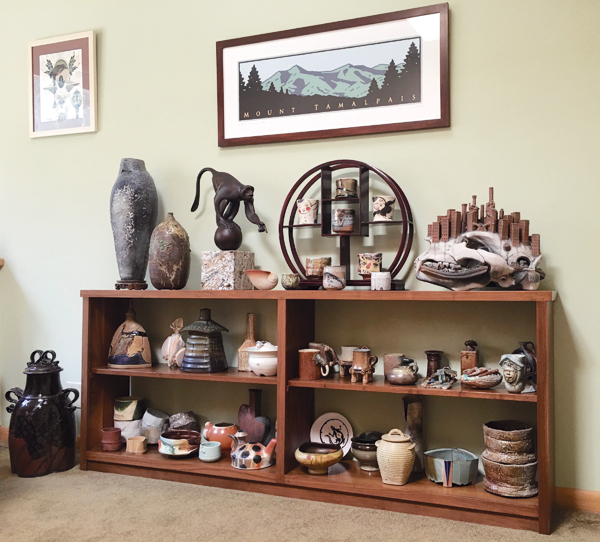 4 Guest room featuring a wide range of functional and sculptural work by a number of different artists, including Bob Nichols’ lidded jar (left of the shelf) and Evan Hobart’s dinosaur skull (top shelf, right).