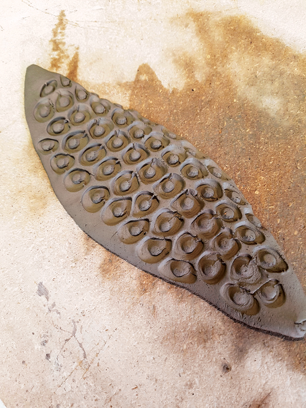 2 The slab that will become the handle as it looks after the stamping and after being tossed to flatten and stretch it.
