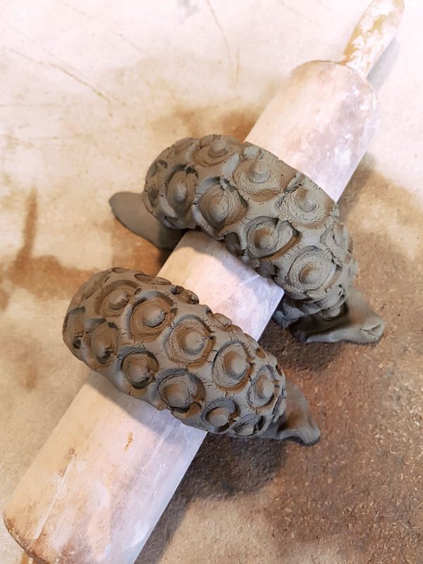 4 Allow the handle to firm up over a rolling pin until it can hold its shape and be attached as a handle.