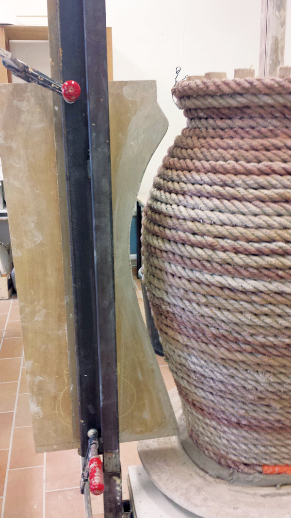 6 Once the rope is secured to the armature, the wooden profile template is clamped to the metal armature.