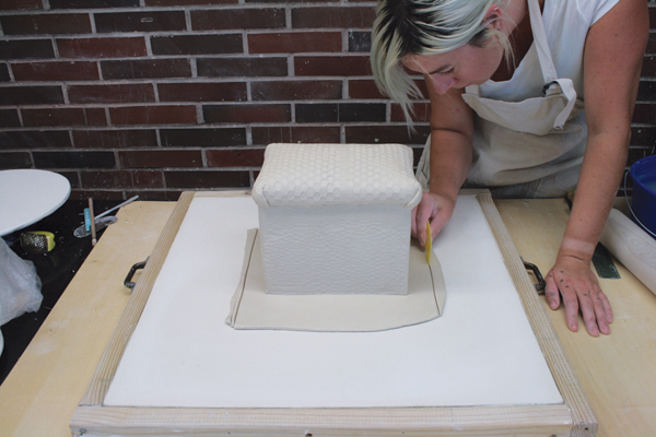 10 Place the paper-textured slab under the large box and then cut and tear the edges.