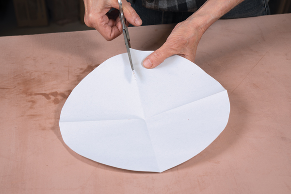 11 Cut out circle from an 11-inch square piece of paper, then cut out a quarter of it to make the template for the stopper.