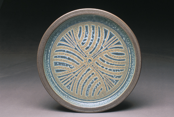 5 Brad Tucker's platter, 18 in. (46 cm) in diameter, stoneware, design carved into dry glaze, over sprayed with contrasting glaze, black slip on rim, 2003.