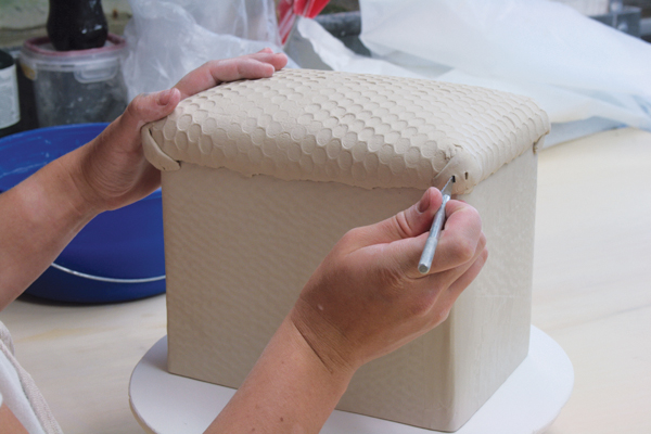 16 Use an X-Acto knife to carefully cut areas for colored-clay embellishments.