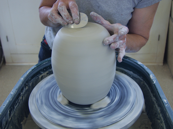 9 Next, flip the form over, secure it to the wheel head, and then trim it to round and smooth this end as you did the other.