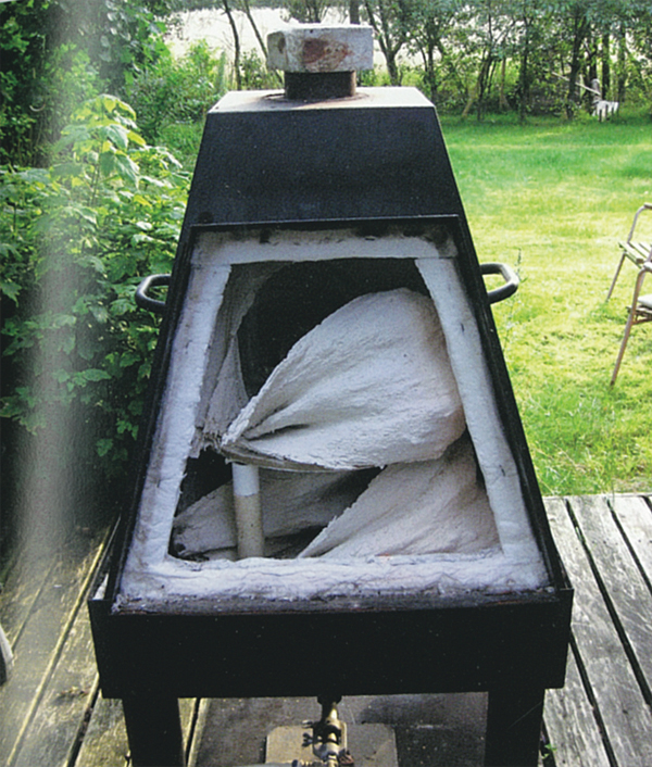 4 The pieces are fired in a gas kiln outside, as there is a lot of smoke from the wood.