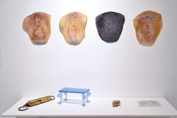 4 Katya Izabel Filmus’ First Generation–Last Generation, 4 ft. (1.2 m) in length, glass, latex embroidery thread, olive tree root, sandblasted inscription, video (edited by Yoav Bezaleli).