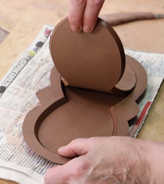 5 Remove the center piece from the base. Keep the cutout piece to use as a support for the base once it’s flipped again.