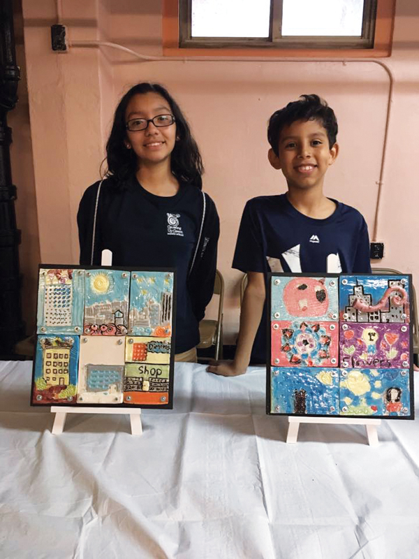 3 Andrea Gamero (l) and Adrian Guerrero (r) with their finished tile plaques, fired to cone 05, for Neighborhood Stories, 2017.