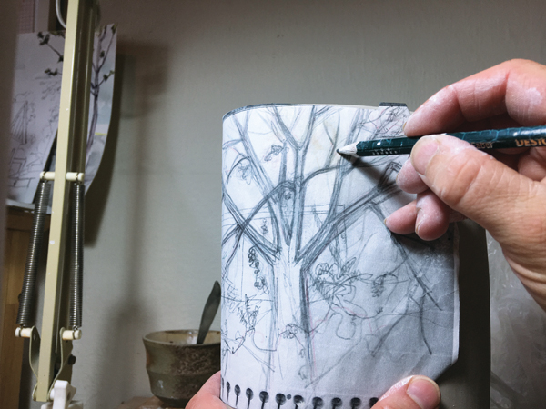 3 After the bottom is attached and the altered cylinder is cleaned up, trace drawings onto the clay.