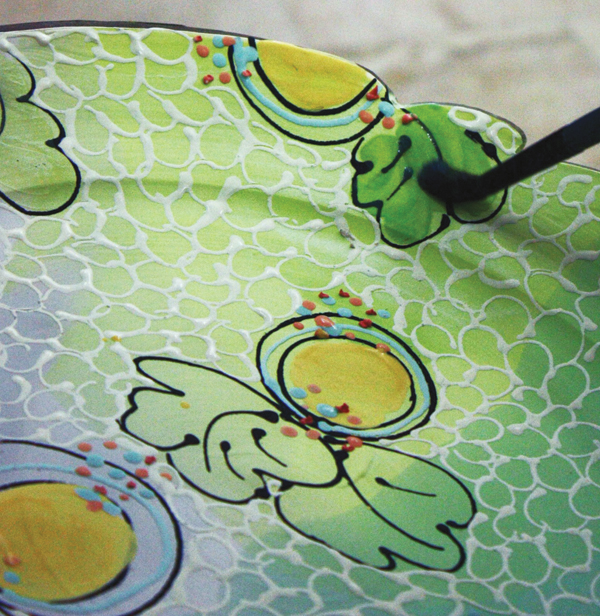 4 Brush another layer of the watered-down underglaze on top of various elements to create depth.