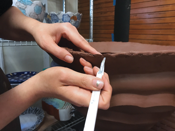 5 After each section is smoothed, cut away any excess clay.