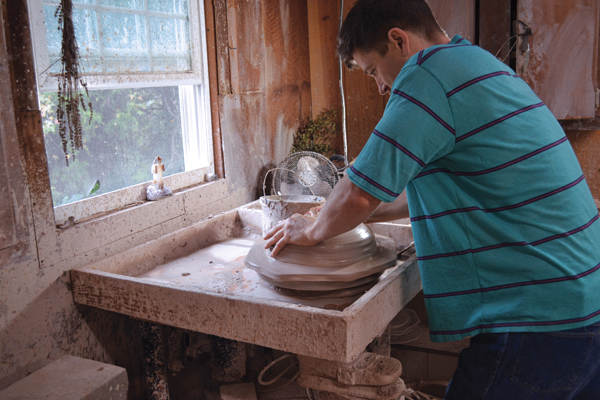 1 Use leverage by standing up to fully center the clay.