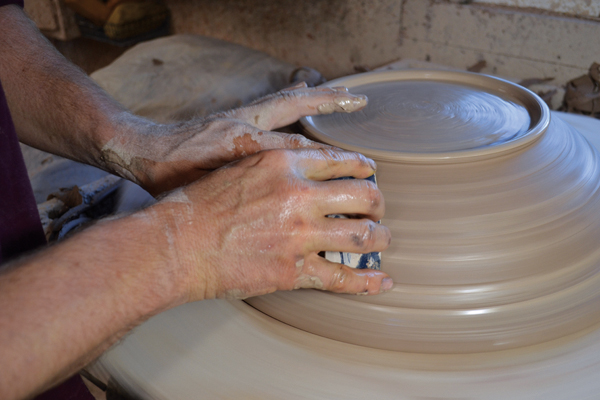 8 Smooth out trim lines and grog from the clay using a rib.