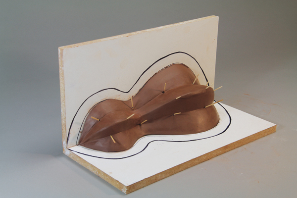 4 Push toothpicks into the high points on the clay model, leaving ½ inch exposed to make it easy to gauge the depth of plaster as you apply it.