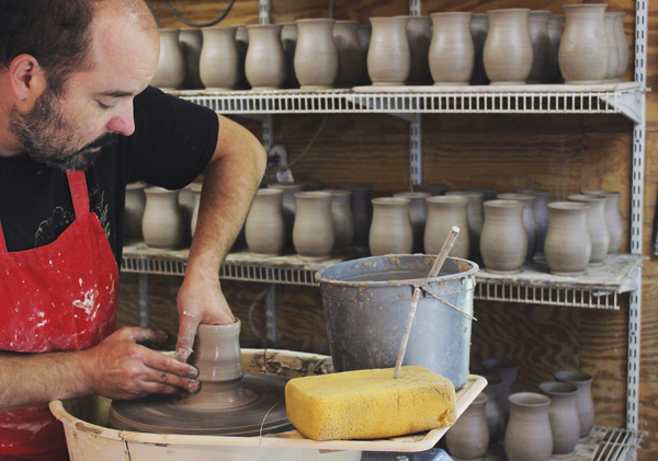 1 Jared Zehmer working on a mug order in his home studio.