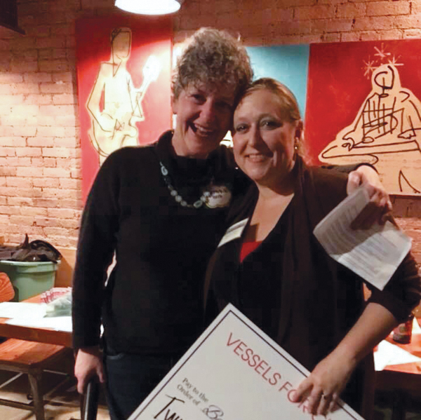 6 Stephanie Boyd (left) presents a check to Berkshire Immigrant Center Director Brooke Mead (right). Photo: Jack Criddle.