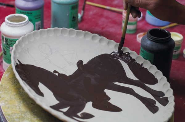 2 Blocking in large areas of color with underglaze.