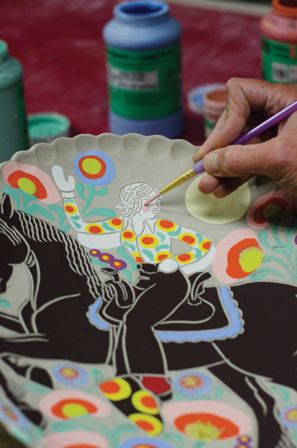 6 Adding detail colors with underglazes using smaller brushes.