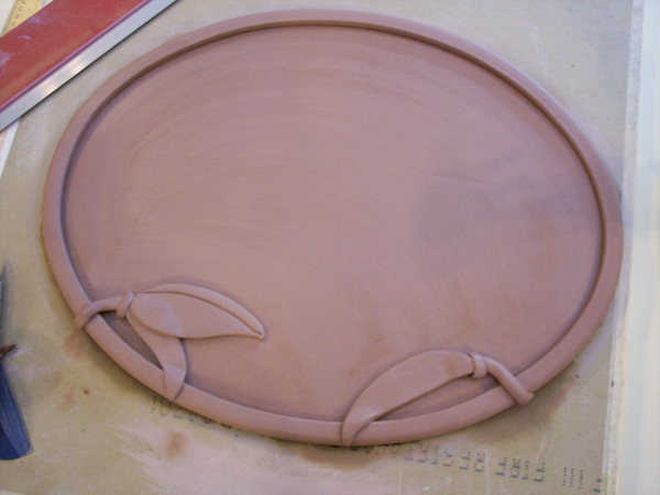 7 Bull-nose edging attached to a slab with added sprig decoration.