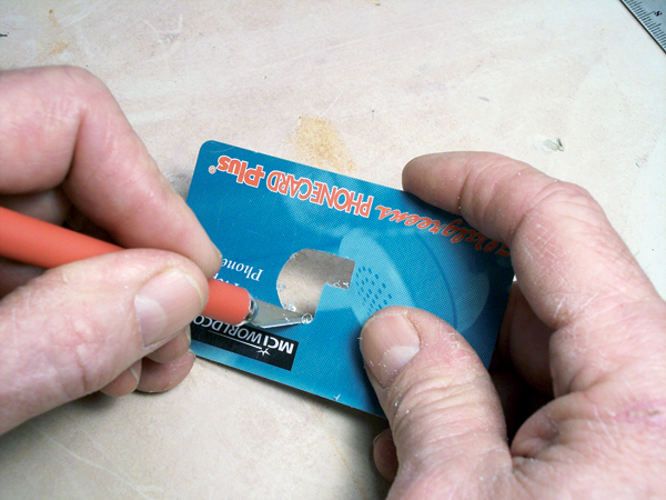 2 Draw the profile of the die on a credit card, then cut out the shape.