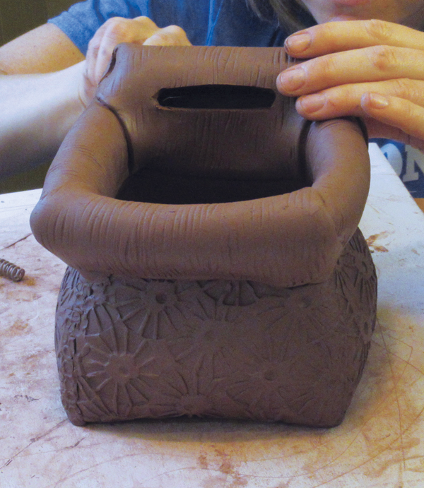 15 Cut out an oval from both the front and back of the tall piece to create a handle.