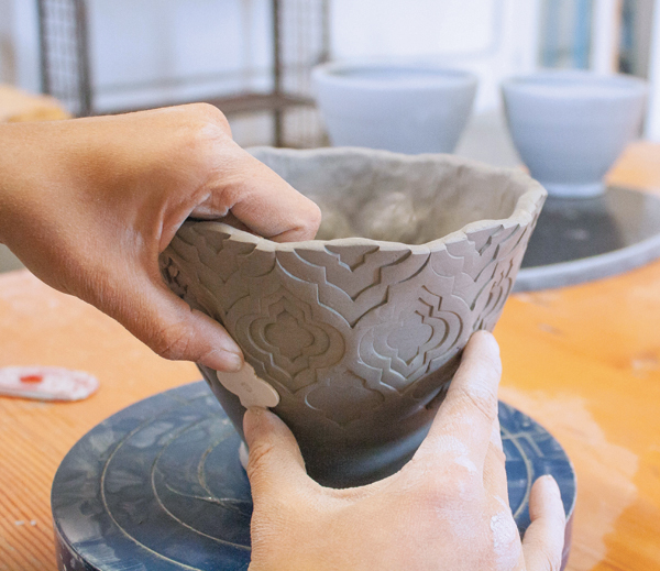 7 Move down the pot for the final row of stamps after adding an additional layer to the previous rows.