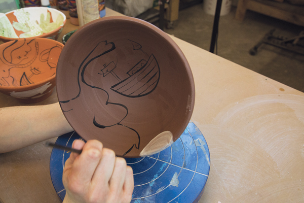  A white background can be placed behind a few images to create emphasis. Turn the pot and paint another image, repeat until the bowl is filled with images that are oriented differently.