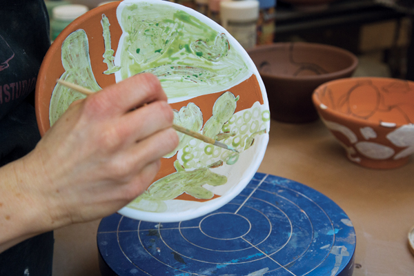 6 Patterns are waxed on areas of turquoise glaze. Here, the pattern is inspired by a blanket.