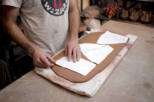 3 Using rough-sized paper templates for cutting slabs to fit into the mold helps cut down on wasted clay.