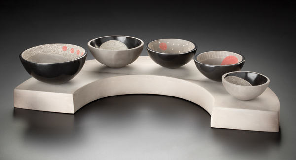 Descending pinch pots on base, 22½ in. (57 cm) in length, pinched and slab-built earthenware, terra sigillata, underglaze, smoke fired to cone 09, 2017. Photo: John Polak.